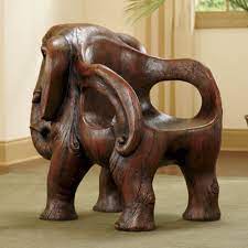 While the chair's back rest extends down to form a minimalist tusk, its arm rests resemble oversized ears. Sumatra Elephant Chair Elephant Home Decor Elephant Decor Unusual Furniture