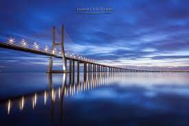 The vasco da gama bridge is a vast stricture that is 17 km (11 miles) long.first opened in 1998 it is still the longest bridge in europe. Top 5 Photo Spots At Vasco Da Gama Bridge Portugal In 2021
