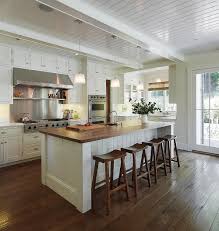 Painted in a benjamin moore white, the kitchen of a nova scotia home designed by alexander gorlin is centered by an island clad in caesarstone; Trendy Kitchen Makeovers 20 Wood Islands That Blend Warmth With Functionality