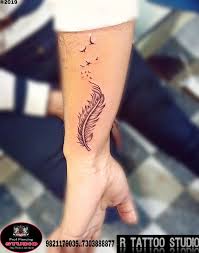 Letter r tattoo is considered as an initial tattoo.initial tattoos can express strong emotions and deep love and that is why many couples and lovers get their partners. Grey Ink Feather With Flying Birds Tattoo Design Done By R Tattoo Studio Flying Bird Tattoo Tattoos Tattoo Designs