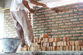 Foundation = same as footing. Worker Laying Bricks To Build House Wall In A Construction Site Stock Photo Picture And Royalty Free Image Image 23330882
