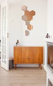 The hexagon shape is a great way to break up the straight lines of a vertical or horizontal gallery display. 12 Hexagonal Mirror Designs Ideas Mirror Designs Design Diy Honeycomb