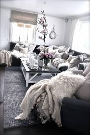 Wood accents—the mantel, pendant light fixture, a mounted basket, and vintage crates—warm the color scheme. We Love This Dark Grey White And Silver Cozy Living Room Decor Livingroom Decor Living Room Decor Cozy Living Room Inspiration Small Living Room Decor