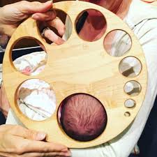 viral image of babys head next to a wooden chart