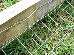 This traditional fence uses wood slats to create a barrier that is both functional and decorative. Simple Way To Make A Wood Fence Dig Proof Dog Fence Diy Dog Fence Dog Backyard
