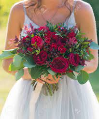 What would your wedding be without fresh flowers? The Bride Is Holding A Bright Red Wedding Bouquet Of Fresh Flowers Stock Photo Picture And Royalty Free Image Image 116449097