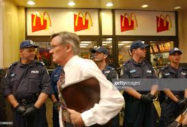 Police Stand Outside A Mcdonalds Restaurant As A Businessman Walks By Mcdonald S Restaurant Police Mcdonalds