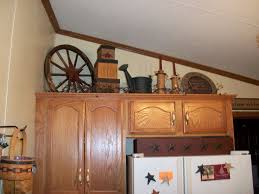 This primitive kitchen decor pinterest graphic has 16 dominated colors, which include thamar black, cab sav, pioneer village, camel hide, petrified oak, namakabe brown, black, del sol maize, burrito, benthic black, crown point cream, yellow emulsion, ivory, honeydew, white, vapour. Decorating Above Kitchen Cabinets Primitive Decorating Above My Kitchen Cabi Decorating Above Kitchen Cabinets Primitive Kitchen Decor Above Kitchen Cabinets