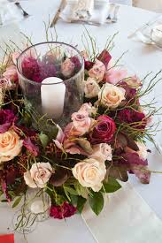 Burgundy And Peach Wedding Table Arrangements A Floral Wreath With Incorporated Ca Table Arrangements Wedding Candle Wedding Centerpieces Wedding Centerpieces