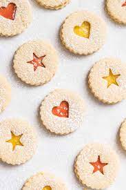 Eric's hungarian grandmother used to make linzer cookies with apricot jam. Traditional Linzer Cookies Plated Cravings