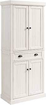 Crafted of poplar solids and engineered wood panels, in a crisp white painted finish, with physical distressing and lightly hand rubbed aged areas on the edges. Amazon Com Crosley Furniture Seaside Kitchen Pantry Cabinet Distressed White Furniture Decor