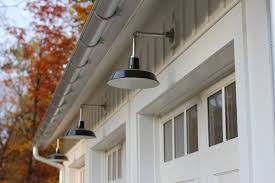 Metal roof accents for a touch of modern drama; Barn Lighting Offers Authentic Feel In Modern Farmhouse Inspiration Modern Farmhouse Exterior Farmhouse Outdoor Lighting Modern Farmhouse Lighting