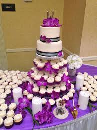 Polished Purple Cupcake Wedding With A Classic 2 Tier Wedding Cake For The Bride And Groom T Wedding Cakes With Cupcakes Cupcake Stand Wedding Wedding Cupcakes