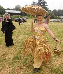 The fabric wings feature gold glitter designs and attached fabric flowers. Interesting Leafy Over Skirt Of A Golden Fairy Costume