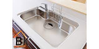 White enamel farmhouse styles kitchen sink with exposed apron. Information On Different Kitchen Sink Materials