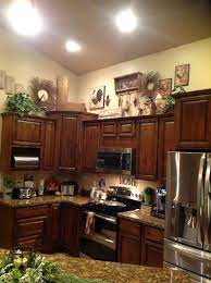 They hold all the space for our necessary ingredients and utensils while keeping things organized and tucked away. I Love Decorating The Tops Of Kitchen Cabinets Decorating Above Kitchen Cabinets Kitchen Cabinets Decor Above Kitchen Cabinets