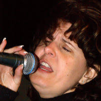 Robet Kieth plays bass guitar during a United Service Organizations (USO)  concert for the 384th Air Expeditionary Wing (AEW), at a forward-deployed  location, in support of Operation ENDURING FREEDOM