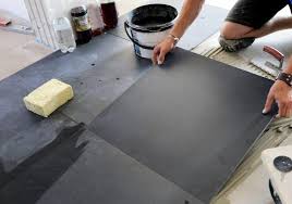 do kitchen cabinets go in before tile