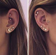 constellation piercing trend arranges tiny earrings all over the ear like stars in the sky galena u constellation piercings cute ear piercings cool piercings