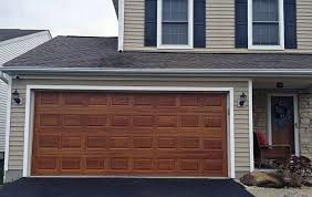 Do paint the trim around the doors either don't paint the garage doors in the same accent color as the front door or shutters. Faux Wood Garage Doors Top Notch Garage Door