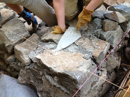 Learn how to lay a flagstone pathway around your home. Building A Stone Foundation This Cob House