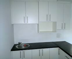 Created By Dimension Cabinets White Melamine Kitchen With Cupboard Storage And Black Slate Postform Tops Cabinet Cabinetry Cupboard Storage