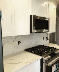 White Shaker Cabinetry With Quartz Full Height Backsplash And Countertops Quartz Kitchen Countertops White Kitchen Remodel Small Countertops