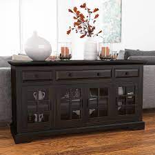 The storage cabinets on the sides are enclosed by a glass door, and the center cabinet comes with a wooden door. Tirana Rustic Solid Wood Glass Door 3 Drawer Large Sideboard Cabinet