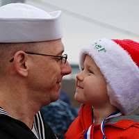 Senior Chief Hospital Corpsman Trevor Dallas-Orr hands blankets and pillows  to Personnel Specialist 1st Class William Clincy and his wife for their  stay at the temporary evacuation site