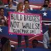 At a campaign event in philadelphia, hillary clinton urges people to vote for an america where people build bridges not walls. 1