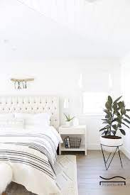 This room has built in dressers saving some floor space. White Bedroom Idea Plant Flower Lamp Simple Minimalist Home Decor Bedroom Decor Bedroom Design