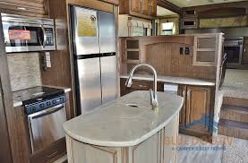 Lower living room with woodstove. Grand Design Solitude 375fl Fifth Wheel Front Living Luxury Blue Dog Rv