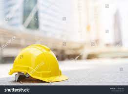 Yellow Hard Safety Wear Helmet Hat In The Project At Construction Site Building On Concrete Floor On City With Sunligh Ad Ad Proje Helmet Hat Hats Yellow