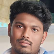 A close-up, high-quality portrait of a stylish Indian young man. He has  well-styled, voluminous dark hair . He is wearing a pastel lavender  crewneck sweater with the name 'Giriraj'embroidered in purple. He
