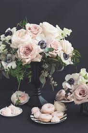 Blush magnolias with pink centers adorn this natural looking brown stem. Pink Black Flower Arrangement Pink Donuts Pink Meringue Anenomes Black Vase Pink Flower Arrangemen Pink Flower Arrangements Floral Wedding Wedding Flowers