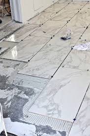 How To Tile Floors Ohmeohmy Blog How To Lay Tile Laying Tile Floor Tile Floor Diy
