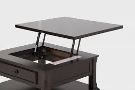 The lift on the coffee table can open up an area for storage inside of the table for books, magazines, remotes, or other small items you have hanging around your living room. Porter Lift Top Cocktail Table By Ashley Furniture Texas Furniture Hut