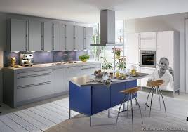 If you aren't ready for rocking a bold blue kitchen or just can't change the color now, try just a blue kitchen island. Kitchen Of The Day A Cool Gray Kitchen With A Blue Island And White Photo Printed Cabinets On The Ri Modern Grey Kitchen Modern Kitchen Design Kitchen Design