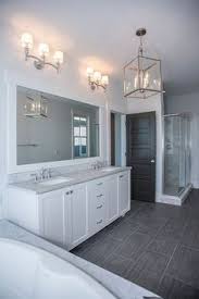 Apr 27, 2020 · in actress lori loughlin's bathroom, high ceilings and a white color scheme make for a modern, airy space. White Bathroom Ideas Polished Nickel Fixtures Grey Marble Bath Surround And Countertops And Dark T Grey Bathroom Floor Grey Bathroom Tiles Bathrooms Remodel