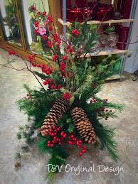 Winter outdoor flowers on alibaba.com when making attractive decorations that last a long time. An Outdoor Pot Filled With Artificial Winter Greens Artificial Berries Sugar Cones And Dogwoo Dried Flower Arrangements Dogwood Branches Floral Arrangements