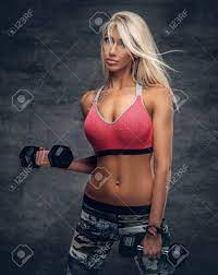 Sexy Blond Woman Fitness Model Holds Dumbbells Over Grey Background Stock Photo Picture And Royalty Free Image Image 71842852