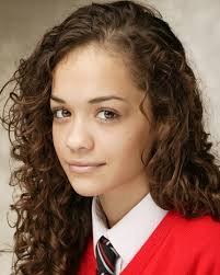 Rita Ora is all smiles as she poses next to plaque in her honour at her old  school