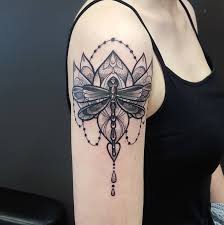 ⇓ tattoo of maori strip of symbols with a small flower in the centre place on a woman's lower. Butterfly Tattoos Dublin The Ink Factory Dublin 2