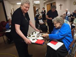 Sr. Marcella Parrish serves grape leaves