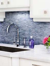 The light gray cabinets without hardware create a flawless look while contrasting with the gray accents' white quartz countertop and backsplash. Backsplash Ideas Gray Backsplash Trendy Kitchen Backsplash Blue Backsplash