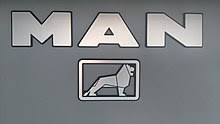 Silhouette of man standing on rock near body of water during daytime. Man Truck Bus Wikipedia