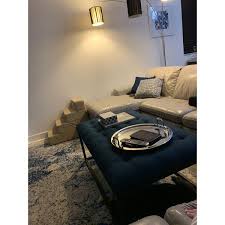 Not sure what's in your curio, but could it be painted a spa blue, or white maybe, to continue the coastal vibe in both rooms? Top Product Reviews For Strick Bolton Renate Navy Linen Coffee Table Ottoman 8840576 Overstock
