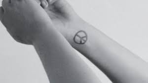 Symbolic meaning of the peace sign. Which World Renowned Singer Is Donning This Dainty Little Peace Sign Tattoo On Her Wrist Quizgriz