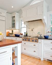 A wood kitchen hood is used to cover a metal exhaust hood especially for many traditional, old world and tuscan kitchen design theme. Decorative Range Hoods Kitchen Victorian With Pendant Lighting Traditional Artificial Floral Arrangements