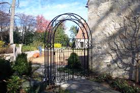 An outdoor trellis with durable metal construction and beautiful scrollwork, all drowned in a quality powder coated finish. Wrought Iron Fences Chicago First Fence Company